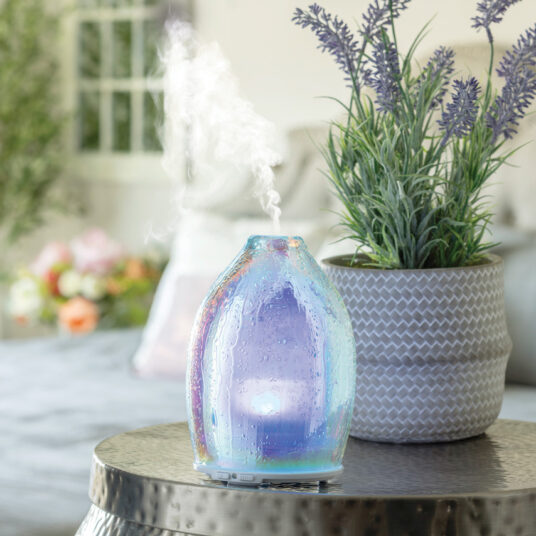 Experience the ultimate in home ambiance with the Iridescent Glow 100 ml Diffuser. This stunning diffuser combines cutting-edge LED technology with a beautiful rain drop design to create a captivating and tranquil atmosphere in any room. When turned on, it offers a mesmerizing display of vibrant colors, thanks to its eight LED lights, transforming your space with a magical, iridescent glow.