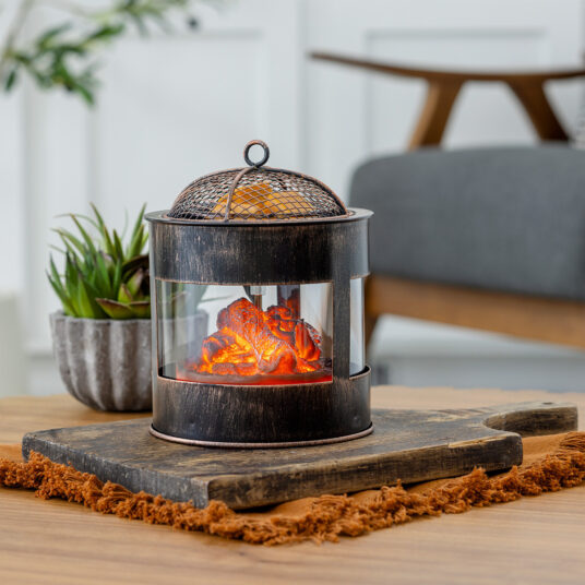 The Fire Pit Wax Warmer brings the cozy ambiance of a crackling fire into your home. The design mimics a rustic fire pit, featuring a mesh lid and the comforting glow of smoldering embers. Enjoy the essence of the outdoors year-round while filling your space with your favorite scents.