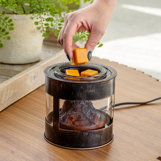 The Fire Pit Wax Warmer brings the cozy ambiance of a crackling fire into your home. The design mimics a rustic fire pit, featuring a mesh lid and the comforting glow of smoldering embers. Enjoy the essence of the outdoors year-round while filling your space with your favorite scents.